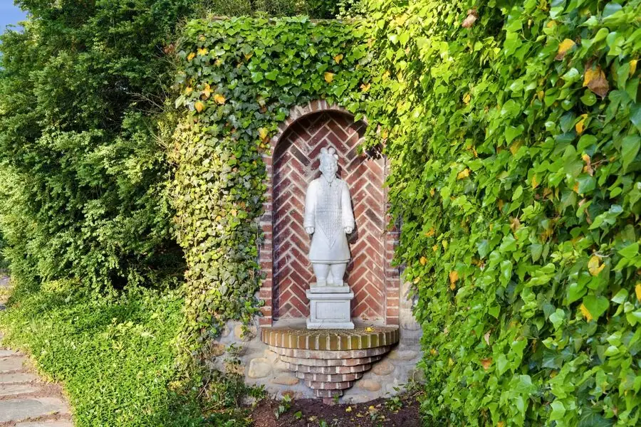 Carved statue niche set into the garden wall