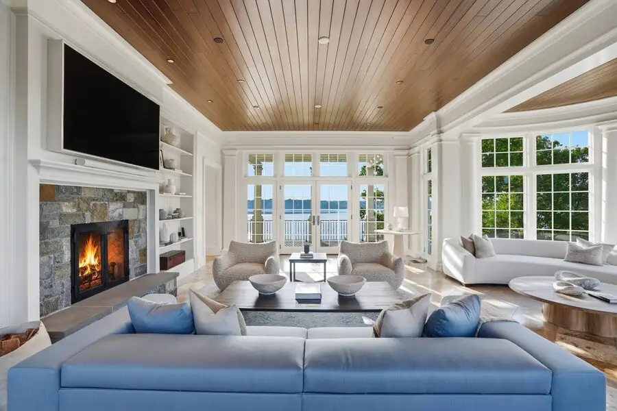 Blue-sofa living beneath a cedar plank ceiling