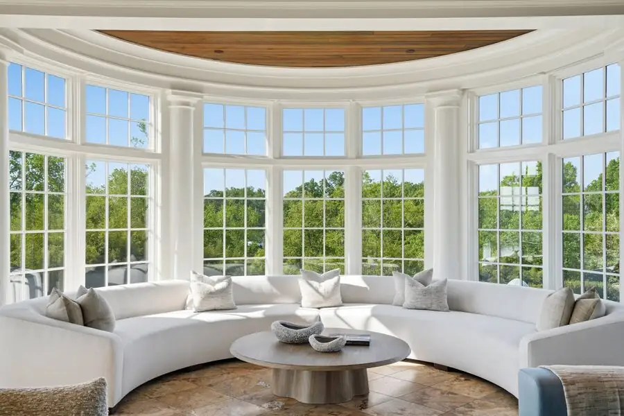 Curved bay sunroom with walls of windows