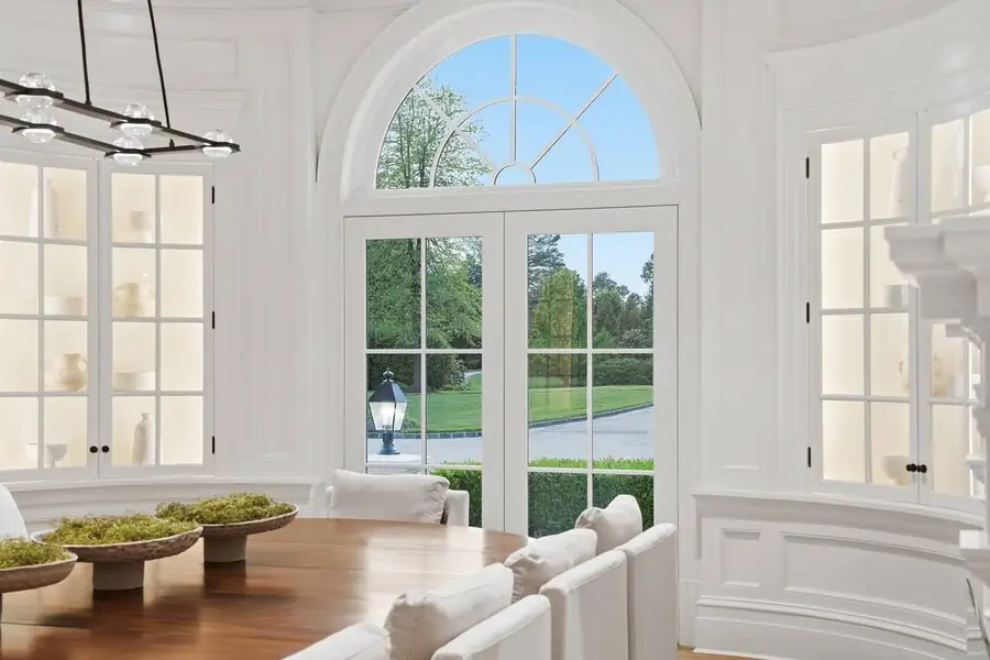 White arched bay with river doors