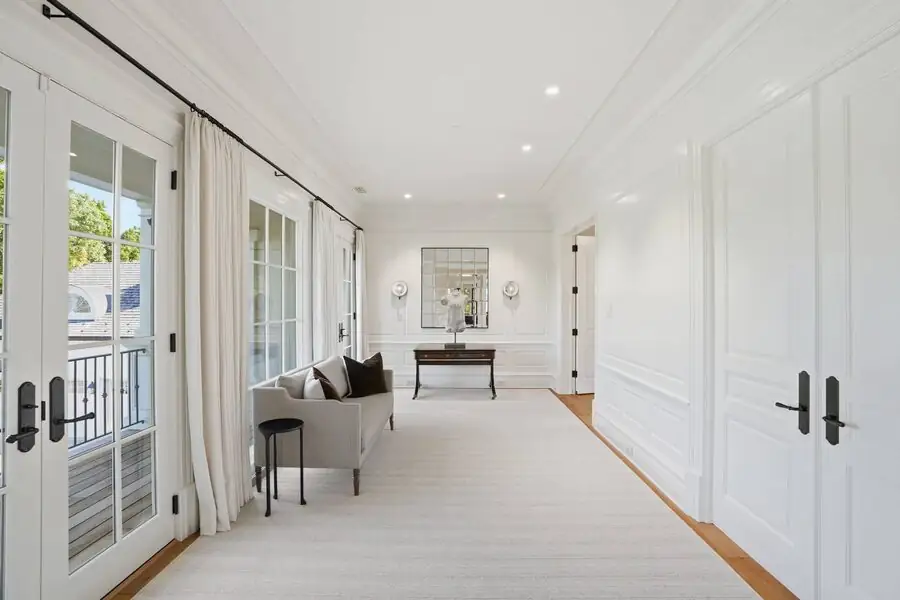 Long upper hall with wall sconces